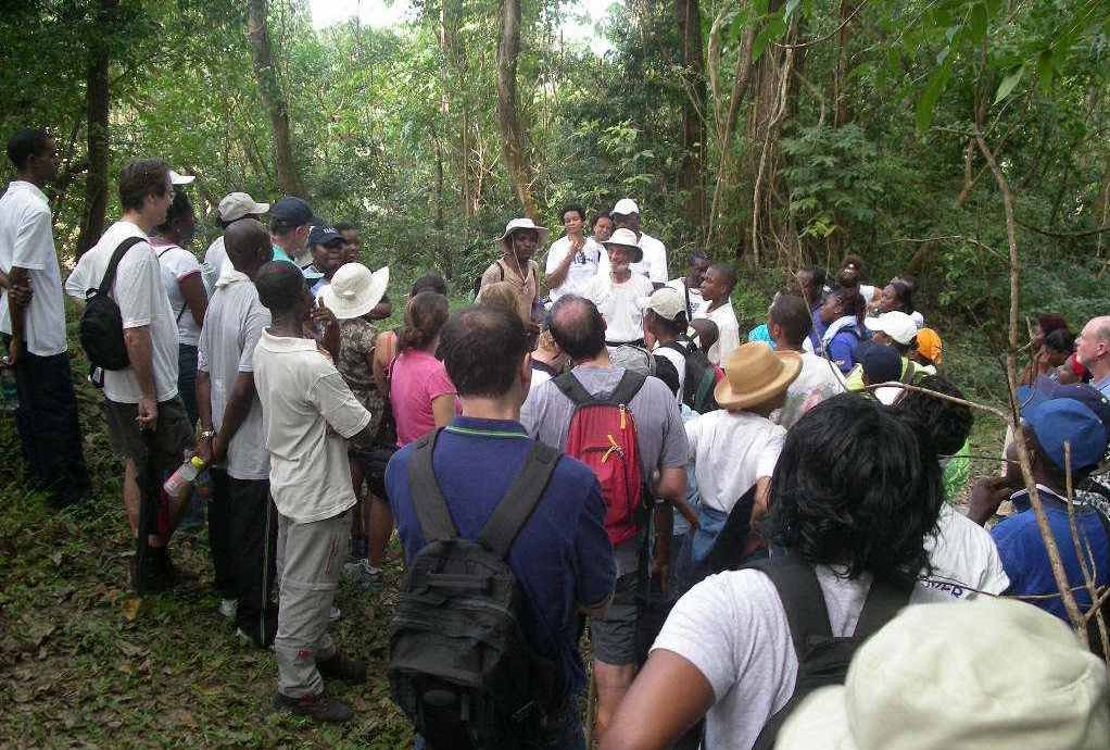 Group of hikers listening to a BNT guide in Turners Hall Woods, St. Thomas, Barbados, surrounded by lush greenery