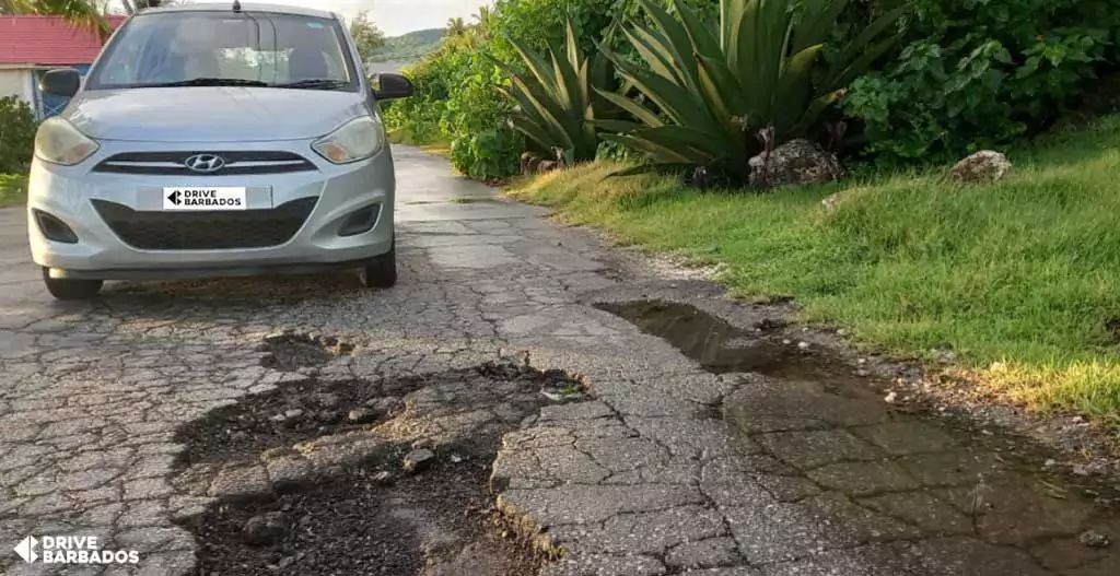 Image Showing Rental Car Infront The Pot Hole