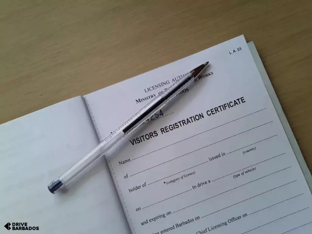 Blank visitor's registration certificate (visitors permit) with pen on top