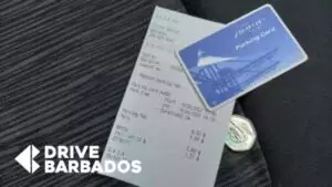 BGI Airport parking fee receipt and membership card on car seat