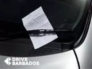 Parking ticket placed under a windshield wiper on a hire car