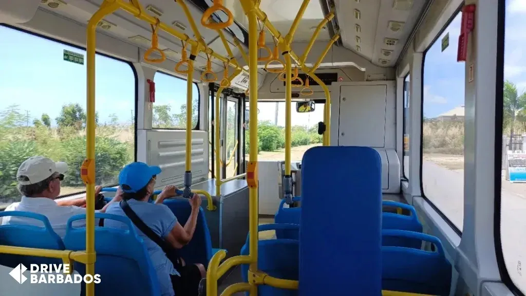 Interior view of a modern public transport bus in Barbados with passengers on board.