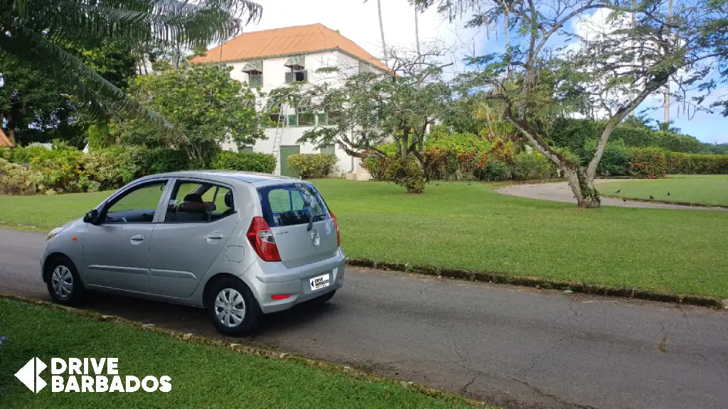economy-car-parked-infront-a-plantation-house